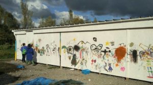Children and their artwork at the refugee camp